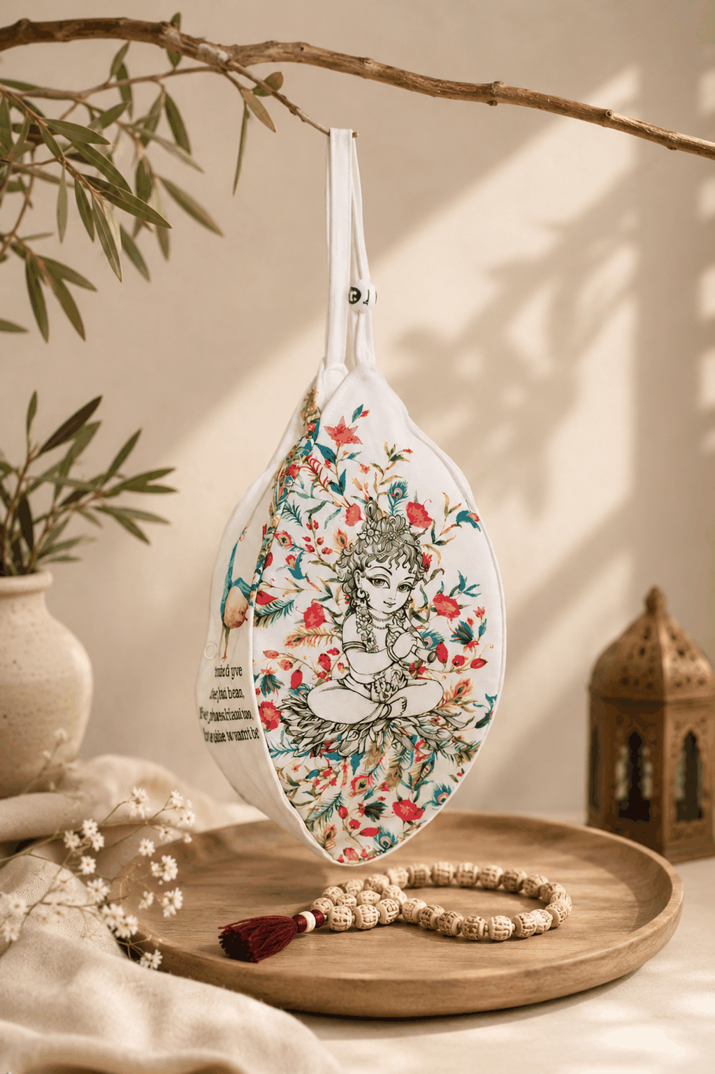 Hand-painted japa bag beside a mala